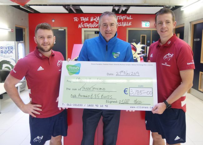 Physios Marc Beggs and Keith Thornhill present a cheque to Brendan Ring of Clionas Foundation.