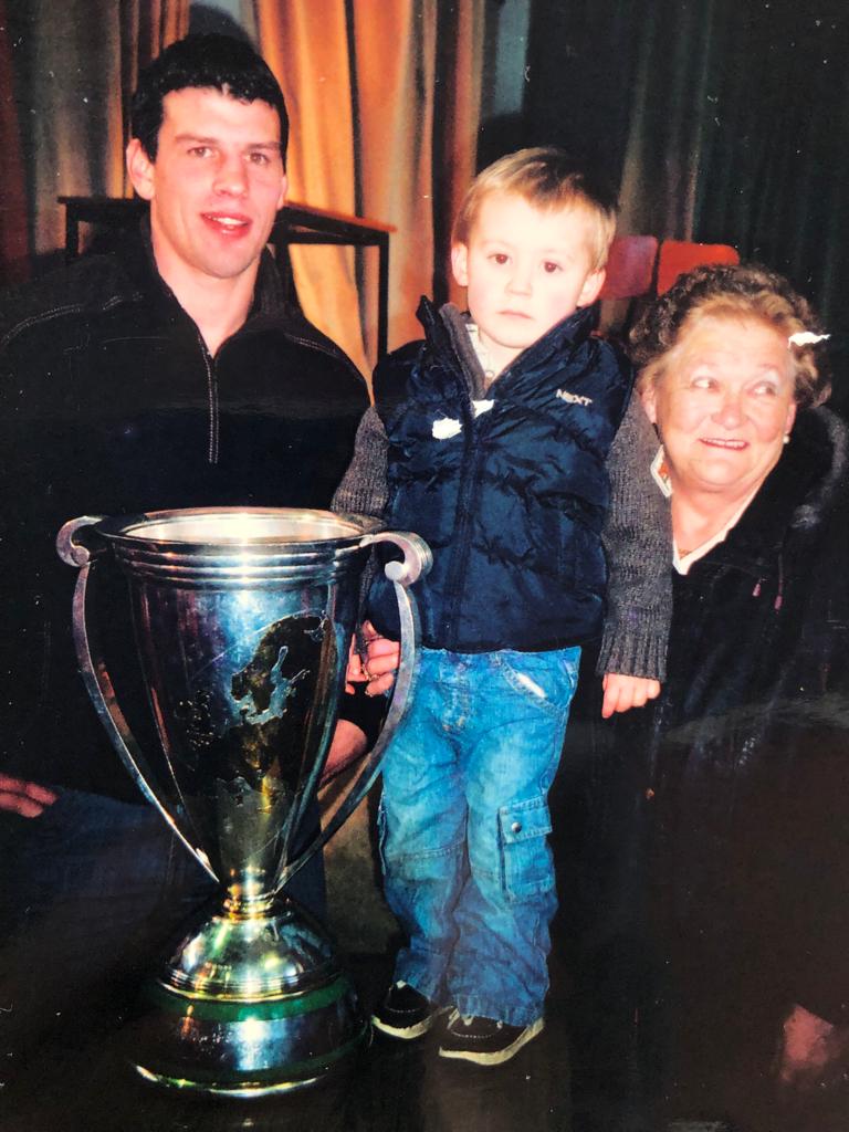 A young Brian Gleeson with Munster Defence Coach Denis Leamy and the European Cup in 2006.
