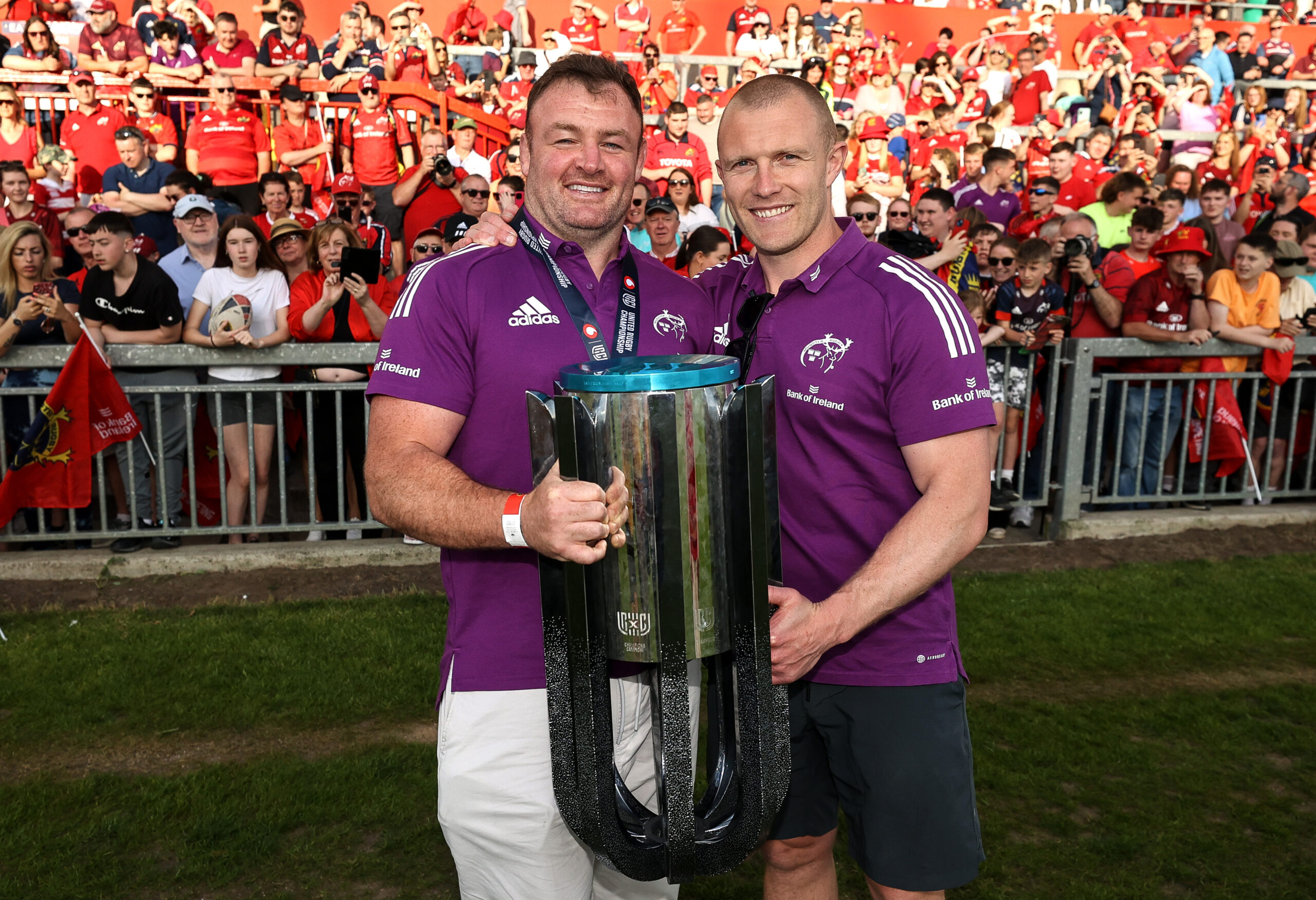 Dave Kilcoyne and Keith Earls celebrate with the URC trophy at the homecoming in Thomond Park. 