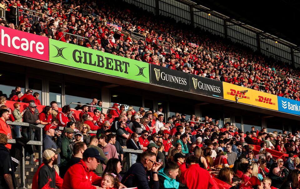 A vew of supporters and signage in Thomond Park