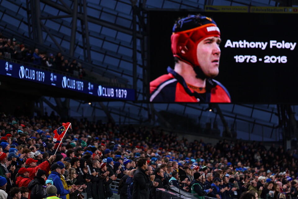 Screen showing Anthony Foley, 1973-2016, over a crowd.