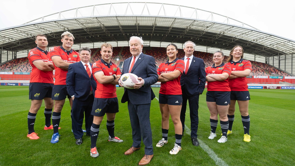 An image featuring members of the Munster Rugby men's and women's team with reps from Ei Electronics.