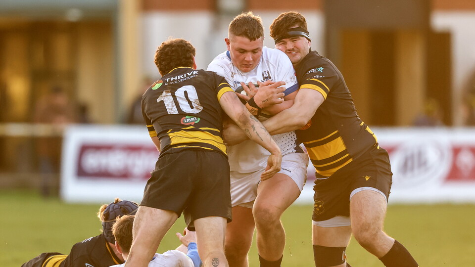 Cork Con's Danny Sheahan is tackled by Kelvin Langan of Young Munster ©INPHO