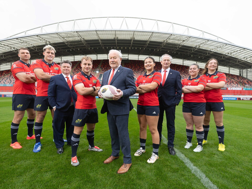 An image featuring members of the Munster Rugby men's and women's team with reps from Ei Electronics.